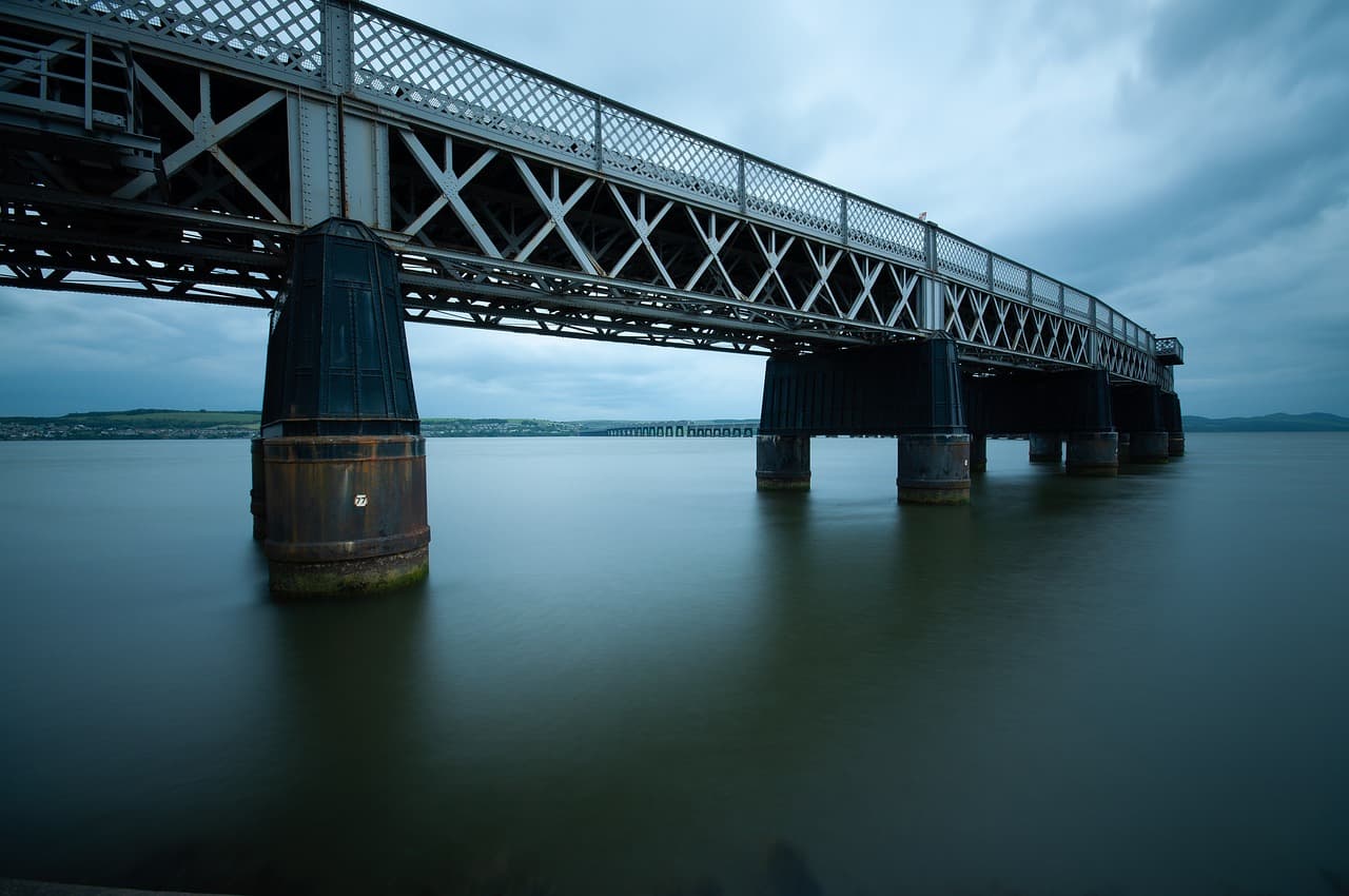 The Tay Rail Bridge running out across the river from Dundee at dusk